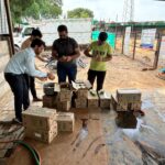 Volunteers feeding dogs curd at animal shelter in June July 2025 Links That Feed campaign